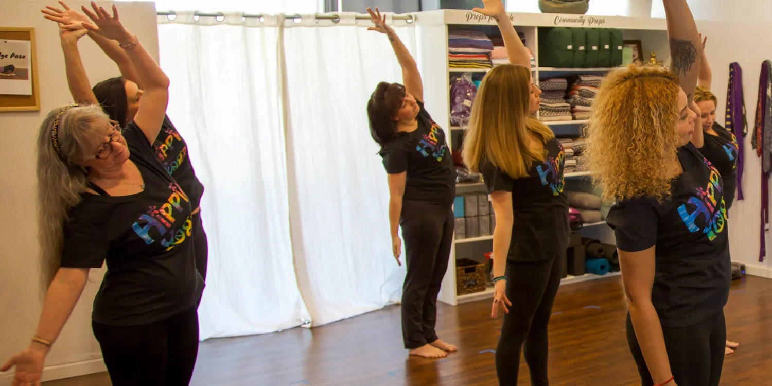 Students stretching together at Hippie Yoga.