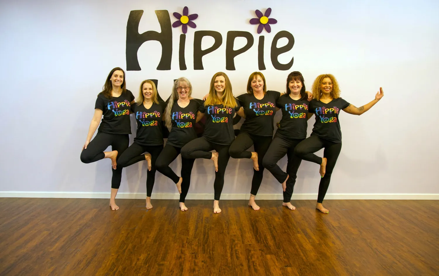 A group practicing tree pose at Hippie Yoga.